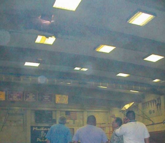 Fire burns beam in high school gym