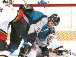 Sharks swamped by Flames in extra period of opener