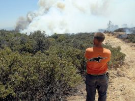 Residents watch as smoke and fire envelop their homes