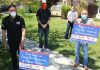 Group distributing signs thanking essential workers
