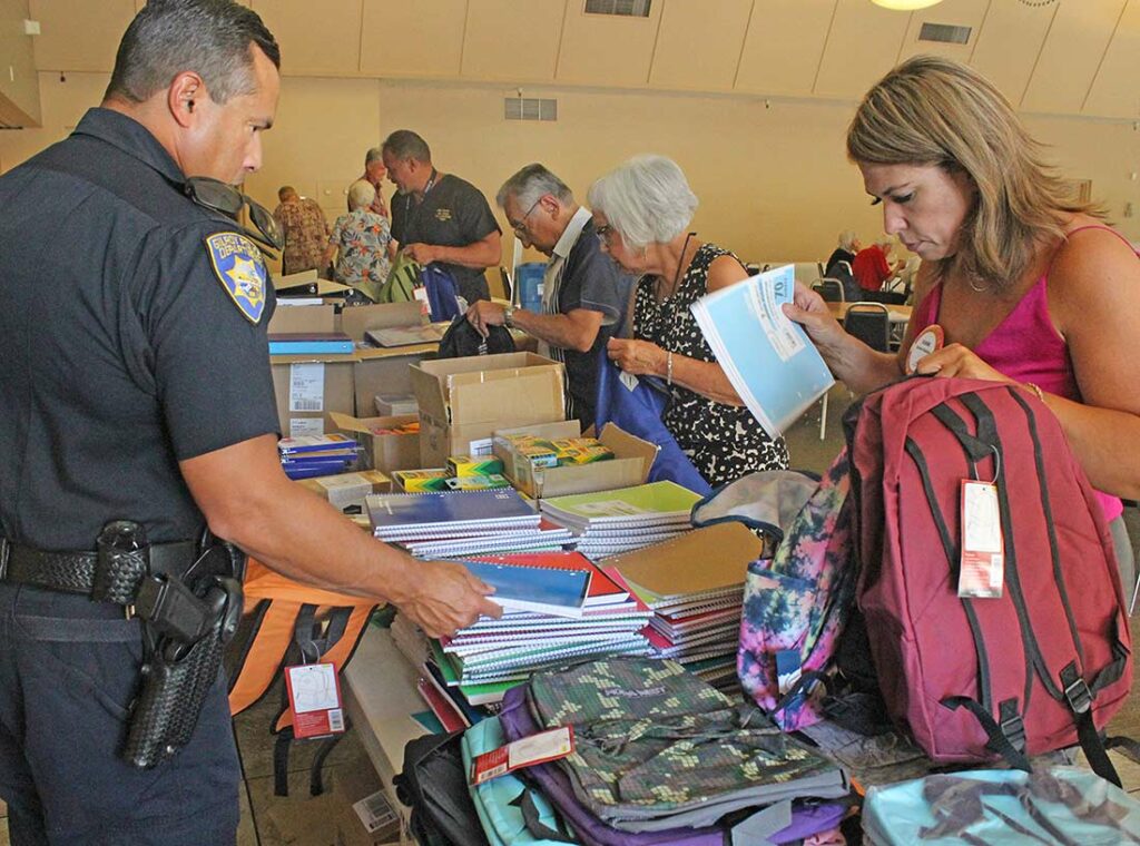 rotary club of gilroy community solutions backpack drive police chief pedro espinoza karine decker