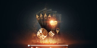A hand holding a smartphone horizontally, from which glowing golden playing cards and dice are digitally emerging, symbolizing online gambling and casino entertainment. The background is dark with a subtle illuminated cityscape silhouette, enhancing the futuristic and dynamic feel of the image.